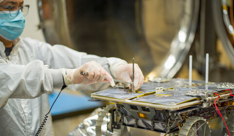NASA engineer preparing CADRE rover for next Moon mission.