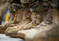 A row of soldiers lined up, focusing on their distinct footwear.