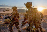 Three fully equipped U.S. Army Green Berets during desert combat training.