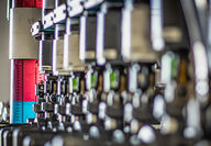 Closeup of columns filled with colorful liquids for rare earths extraction.