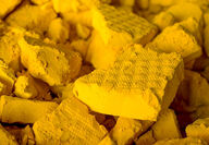 A high-definition close-up photo of uranium concentrate or yellowcake.