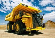 A brand new two-story tall Komatsu mining haul truck at a test site.