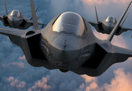 Up close photo of three F-35 fighter jets flying in close formation.