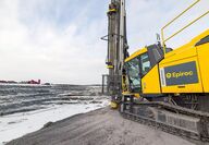 Close-up of a SmartROC D65 surface drill rig at the edge of a quarry.