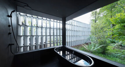 Interior of the Karuizawa house showing a view of the outside over a tub.